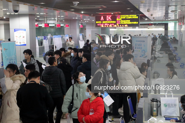 Job seekers are looking for positions at a job fair for 2024 college graduates in Suzhou, Jiangsu Province, China, on January 19, 2024. 