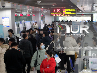 Job seekers are looking for positions at a job fair for 2024 college graduates in Suzhou, Jiangsu Province, China, on January 19, 2024. (