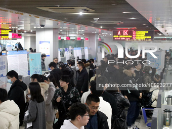 Job seekers are looking for positions at a job fair for 2024 college graduates in Suzhou, Jiangsu Province, China, on January 19, 2024. (