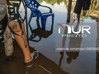 A prosthetic leg is lying beside a pillar in the Sicanang settlement, which is experiencing tidal flooding in Medan, North Sumatra Province,...