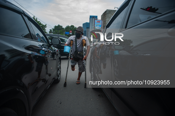 Tukino, 56, a resident of a leprosy settlement, is asking for alms at a traffic intersection in Medan, North Sumatra Province, Indonesia, on...