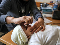 A UNRWA employee is providing a Polio vaccine in a clinic in Deir al-Balah, central Gaza Strip, on January 21, 2024, amid ongoing battles be...