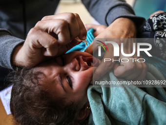 A UNRWA employee is providing a Polio vaccine in a clinic in Deir al-Balah, central Gaza Strip, on January 21, 2024, amid ongoing battles be...