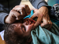 A UNRWA employee is providing a Polio vaccine in a clinic in Deir al-Balah, central Gaza Strip, on January 21, 2024, amid ongoing battles be...