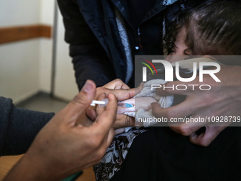 A UNRWA employee is providing a Polio vaccine in a clinic in Deir al-Balah, central Gaza Strip, on January 21, 2024, amid ongoing battles be...