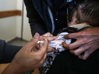 A UNRWA employee is providing a Polio vaccine in a clinic in Deir al-Balah, central Gaza Strip, on January 21, 2024, amid ongoing battles be...