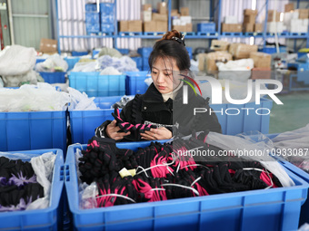 A worker is producing protective equipment for export in Lianyungang, China, on January 22, 2024. (