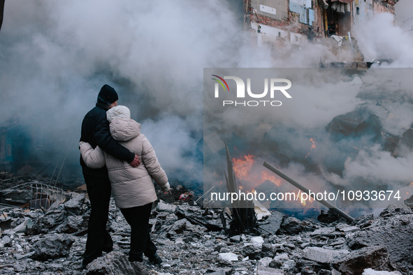 People are standing near the site of the missile strike, in Kharkiv, Ukraine, on January 23, 2024. On The Morning Of January 23, 2024, Russi...