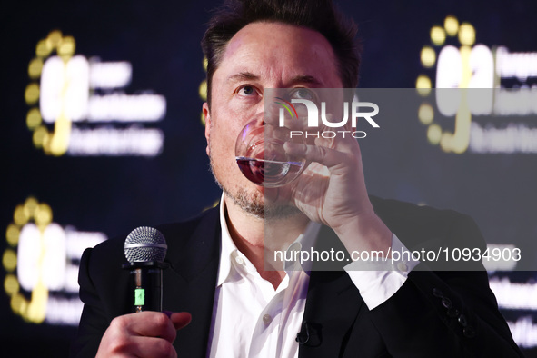 Elon Musk, owner of Tesla and the X (formerly Twitter) platform, is drinking water while attending a symposium on fighting antisemitism titl...