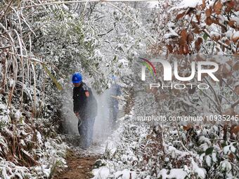 Workers are inspecting power supply lines in the cold mountainous area of Dongling village in Liuzhou, China, on January 23, 2024. (