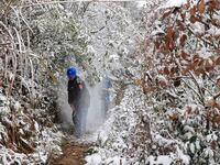 Workers are inspecting power supply lines in the cold mountainous area of Dongling village in Liuzhou, China, on January 23, 2024. (