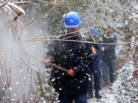 Workers are inspecting power supply lines in the cold mountainous area of Dongling village in Liuzhou, China, on January 23, 2024. (