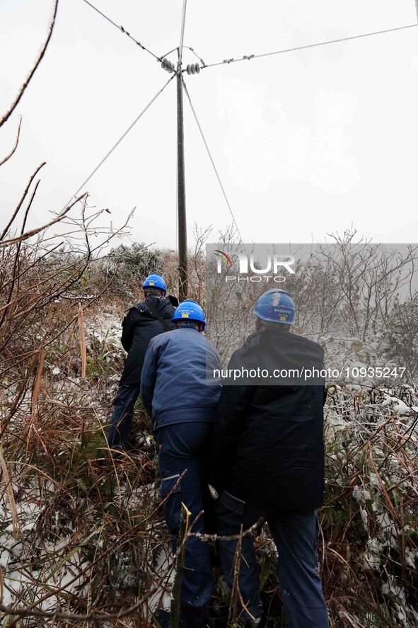 Workers are inspecting power supply lines in the cold mountainous area of Dongling village in Liuzhou, China, on January 23, 2024. 