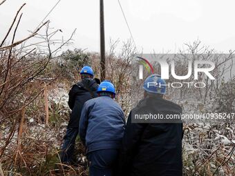 Workers are inspecting power supply lines in the cold mountainous area of Dongling village in Liuzhou, China, on January 23, 2024. (