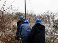 Workers are inspecting power supply lines in the cold mountainous area of Dongling village in Liuzhou, China, on January 23, 2024. (