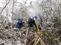 Workers are inspecting power supply lines in the cold mountainous area of Dongling village in Liuzhou, China, on January 23, 2024. (