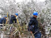 Workers are inspecting power supply lines in the cold mountainous area of Dongling village in Liuzhou, China, on January 23, 2024. (