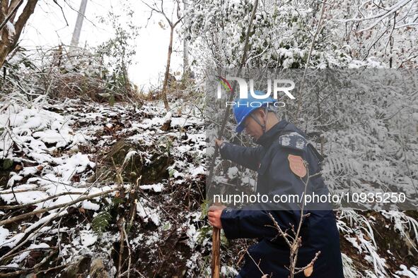 Workers are inspecting power supply lines in the cold mountainous area of Dongling village in Liuzhou, China, on January 23, 2024. 