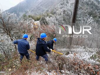 Workers are inspecting power supply lines in the cold mountainous area of Dongling village in Liuzhou, China, on January 23, 2024. (