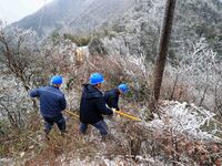 Workers are inspecting power supply lines in the cold mountainous area of Dongling village in Liuzhou, China, on January 23, 2024. (