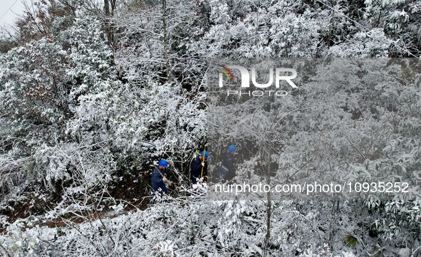 Workers are inspecting power supply lines in the cold mountainous area of Dongling village in Liuzhou, China, on January 23, 2024. 