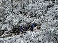 Workers are inspecting power supply lines in the cold mountainous area of Dongling village in Liuzhou, China, on January 23, 2024. (