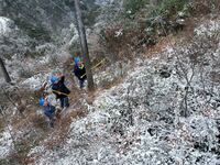 Workers are inspecting power supply lines in the cold mountainous area of Dongling village in Liuzhou, China, on January 23, 2024. (