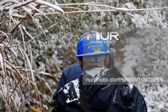 Workers are inspecting power supply lines in the cold mountainous area of Dongling village in Liuzhou, China, on January 23, 2024. 