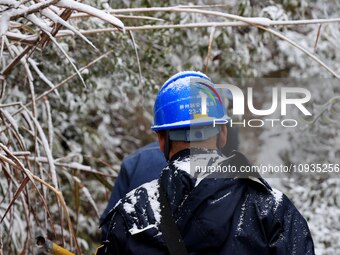 Workers are inspecting power supply lines in the cold mountainous area of Dongling village in Liuzhou, China, on January 23, 2024. (