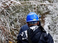 Workers are inspecting power supply lines in the cold mountainous area of Dongling village in Liuzhou, China, on January 23, 2024. (