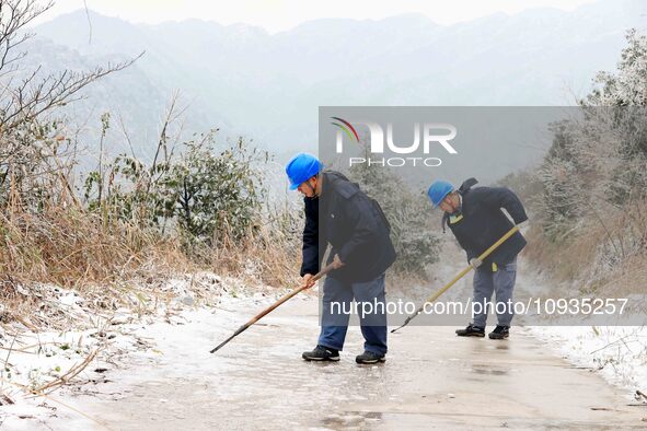 Workers are inspecting power supply lines in the cold mountainous area of Dongling village in Liuzhou, China, on January 23, 2024. 