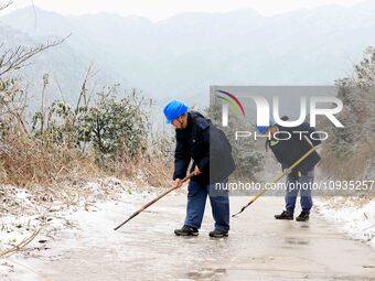 Workers are inspecting power supply lines in the cold mountainous area of Dongling village in Liuzhou, China, on January 23, 2024. (