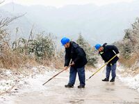 Workers are inspecting power supply lines in the cold mountainous area of Dongling village in Liuzhou, China, on January 23, 2024. (