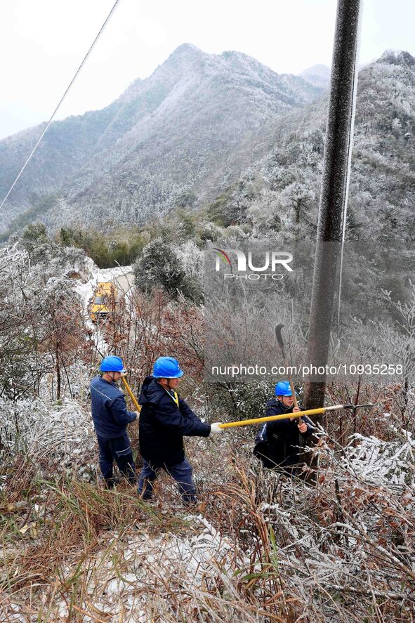 Workers are inspecting power supply lines in the cold mountainous area of Dongling village in Liuzhou, China, on January 23, 2024. 