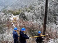 Workers are inspecting power supply lines in the cold mountainous area of Dongling village in Liuzhou, China, on January 23, 2024. (