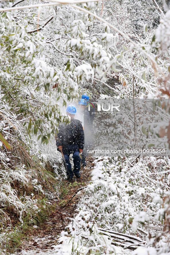 Workers are inspecting power supply lines in the cold mountainous area of Dongling village in Liuzhou, China, on January 23, 2024. 