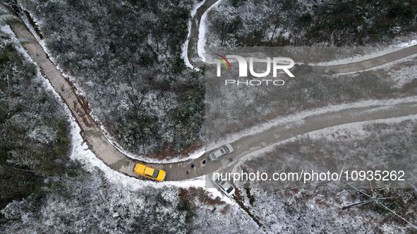 Workers are inspecting power supply lines in the cold mountainous area of Dongling village in Liuzhou, China, on January 23, 2024. 