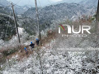 Workers are inspecting power supply lines in the cold mountainous area of Dongling village in Liuzhou, China, on January 23, 2024. (