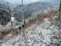 Workers are inspecting power supply lines in the cold mountainous area of Dongling village in Liuzhou, China, on January 23, 2024. (