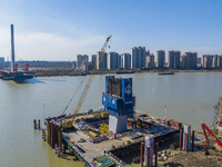 Workers are speeding up the construction of Taoyuan Bridge on the Beijing-Hangzhou Grand Canal in Suqian, East China's Jiangsu province, on...