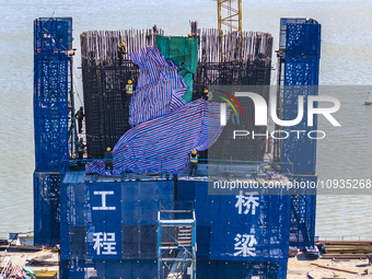 Workers are speeding up the construction of Taoyuan Bridge on the Beijing-Hangzhou Grand Canal in Suqian, East China's Jiangsu province, on...