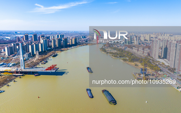 Workers are speeding up the construction of Taoyuan Bridge on the Beijing-Hangzhou Grand Canal in Suqian, East China's Jiangsu province, on...