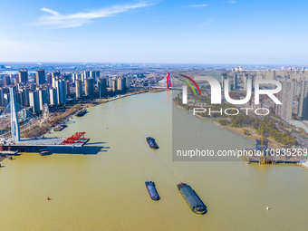 Workers are speeding up the construction of Taoyuan Bridge on the Beijing-Hangzhou Grand Canal in Suqian, East China's Jiangsu province, on...