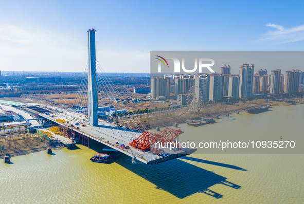 Workers are speeding up the construction of Taoyuan Bridge on the Beijing-Hangzhou Grand Canal in Suqian, East China's Jiangsu province, on...