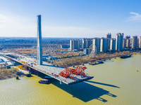 Workers are speeding up the construction of Taoyuan Bridge on the Beijing-Hangzhou Grand Canal in Suqian, East China's Jiangsu province, on...