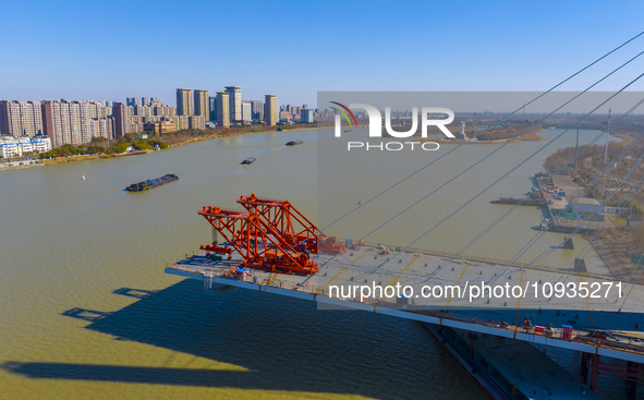 Workers are speeding up the construction of Taoyuan Bridge on the Beijing-Hangzhou Grand Canal in Suqian, East China's Jiangsu province, on...