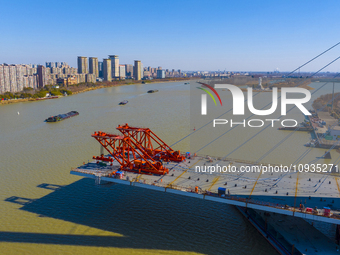 Workers are speeding up the construction of Taoyuan Bridge on the Beijing-Hangzhou Grand Canal in Suqian, East China's Jiangsu province, on...