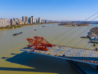 Workers are speeding up the construction of Taoyuan Bridge on the Beijing-Hangzhou Grand Canal in Suqian, East China's Jiangsu province, on...