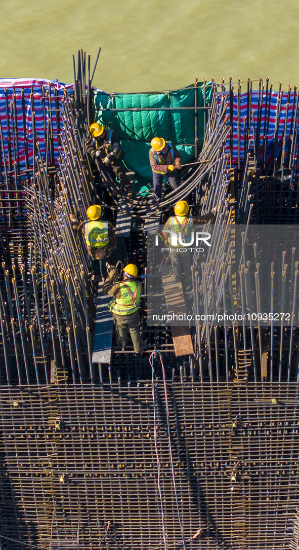 Workers are speeding up the construction of Taoyuan Bridge on the Beijing-Hangzhou Grand Canal in Suqian, East China's Jiangsu province, on...