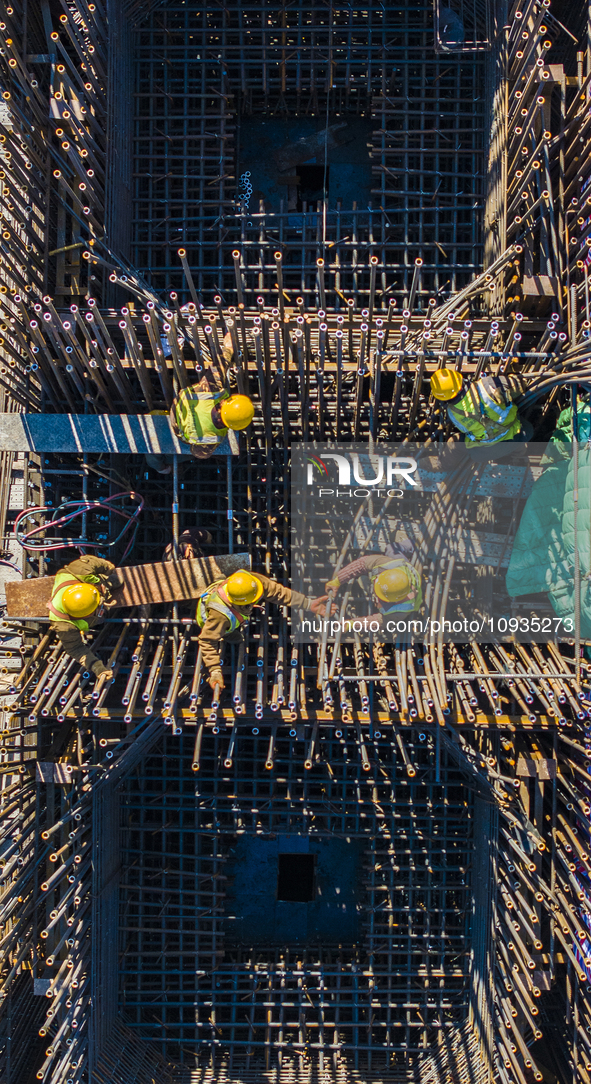 Workers are speeding up the construction of Taoyuan Bridge on the Beijing-Hangzhou Grand Canal in Suqian, East China's Jiangsu province, on...